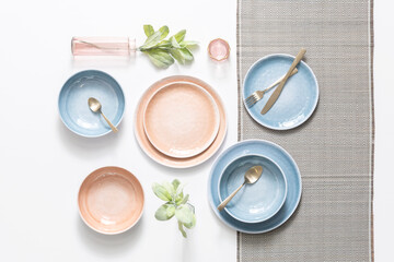 Top view of minimal table setting concept for stylish breakfast or brunch, featuring paired ceramic...