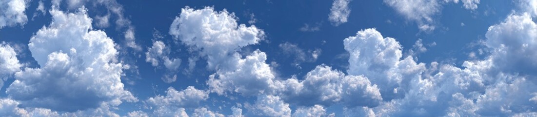 Fototapeta premium Fluffy white clouds scattered across a vibrant blue sky