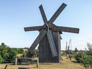 Traditional wooden windmill with detailed blade construction in Pustoviitivka village, Sumy region,...