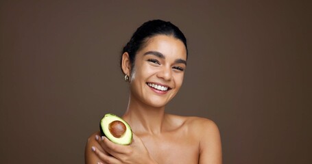Beauty, woman and portrait with avocado in studio for natural skincare, dermatology or omega 3 on...