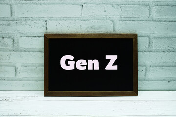 Gen Z text with blackboard on white brick background