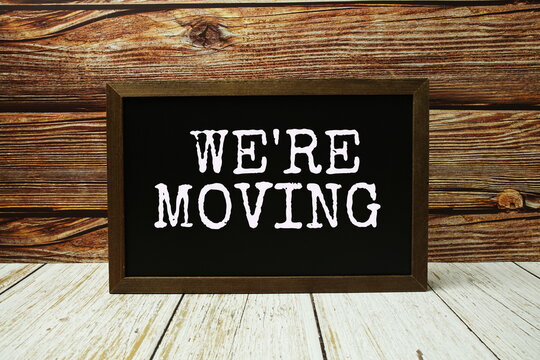We're moving text with blackboard on wooden background