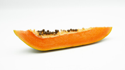 Piece of ripe papaya fruit with seeds isolated on white