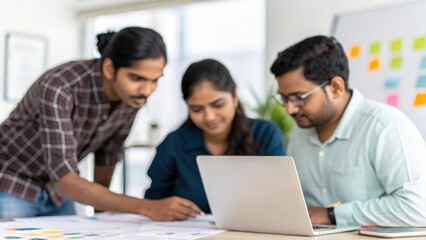 Indian tech team collaborating on UX design mockups for client project	
