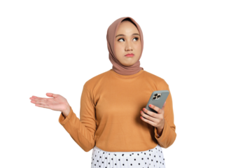 Confused Muslim woman in hijab holding smartphone and raising hand isolated on transparent background