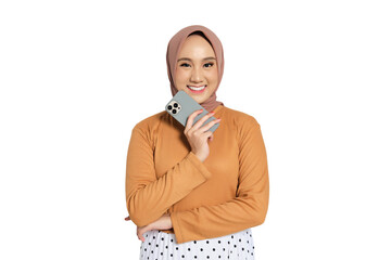 Cheerful Muslim woman in hijab smiling while holding smartphone to cheek isolated on transparent background