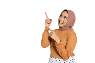 Smiling Muslim woman in hijab pointing upward with both hands isolated on transparent background