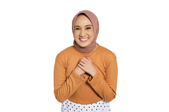 Grateful Muslim woman in hijab smiling and holding hands on chest with thankful expression isolated on transparent background - Powered by Adobe