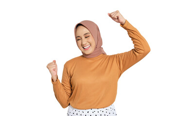 Cheerful woman wearing hijab celebrating success with raised fists isolated on transparent...
