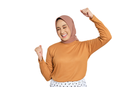 Cheerful woman wearing hijab celebrating success with raised fists isolated on transparent background