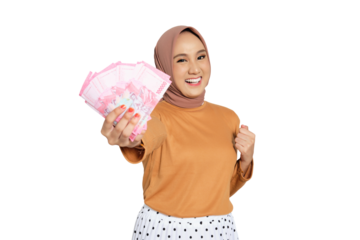 Happy woman wearing hijab holding Indonesian rupiah cash and smiling with excitement isolated on transparent background