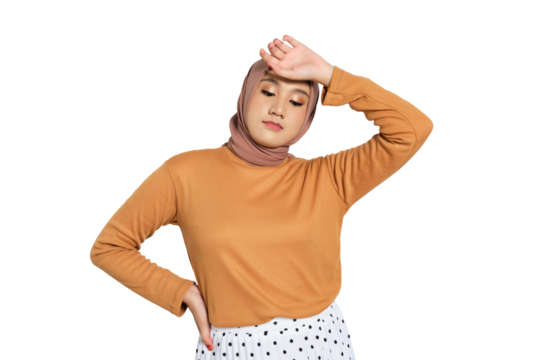 Tired young Muslim woman in hijab touching forehead and closing eyes isolated on transparent background