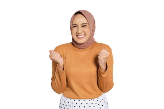 Cheerful woman wearing hijab celebrating success with raised fists isolated on transparent background