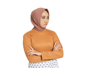 Unhappy young Muslim woman in hijab crossing arms and looking away with displeased expression isolated on transparent background