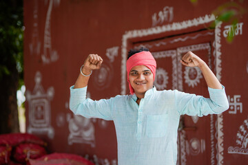 young indian farmer giving happy expression