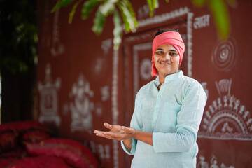 young indian farmer giving happy expression