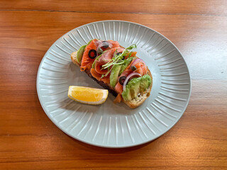 Open smoked salmon sandwich with avocado 
