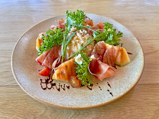 Smoked salmon and cantaloupe salad with cheese 
