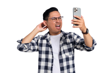 Confused young man wearing glasses scratching head and looking at smartphone screen with puzzled expression isolated on transparent background