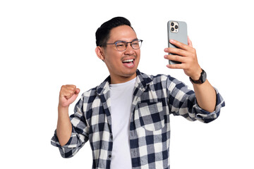 Excited young man in checkered shirt clenching fist while looking at smartphone screen with happy expression isolated on transparent background