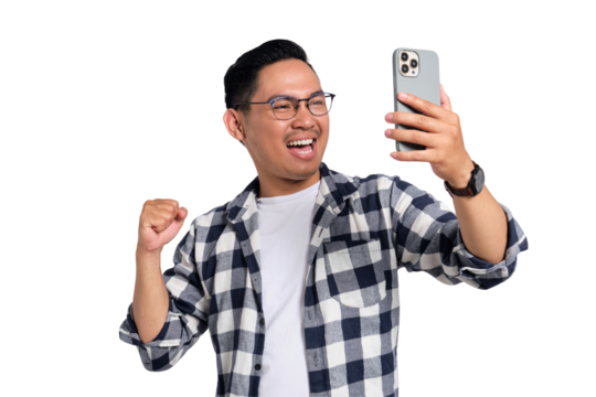 Excited young man in checkered shirt clenching fist while looking at smartphone screen with happy expression isolated on transparent background