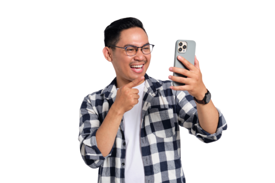 Smiling young man in glasses pointing at smartphone screen while looking excited and happy isolated on transparent background