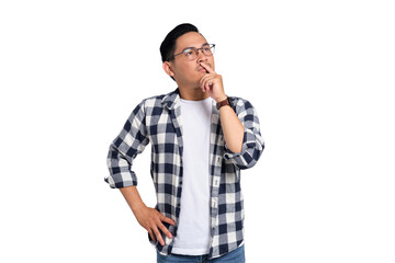 Pensive young man in glasses and checkered shirt touching lips while thinking deeply with serious...