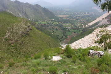 A breathtaking landscape in Swat, KPK, featuring majestic mountains and abundant greenery under a...