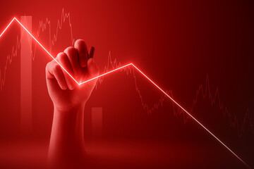 A hand draws a downward trending red graph line, symbolizing a market decline