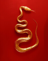 Close up of a golden snake on red. Generative AI