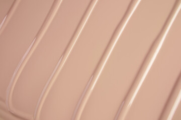 delicate parallel stripes of foundation liquid powder. Cosmetic beautiful background. A copy of the...