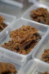 Close up of golden brown, crispy beef pieces packed in clear plastic containers	