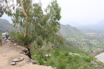A breathtaking landscape in Swat, KPK, featuring majestic mountains and abundant greenery under a...