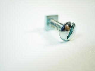 A close-up view presents a T-Slot bolt lying on a white surface, showcasing threads and head...