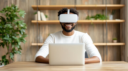 Virtual reality user smiling while working on laptop in modern office environment