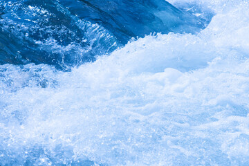 Blue water with ripples on the surface. Defocus blurred transparent blue colored clear calm water...