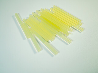 Close up presents several yellow glue sticks ready for crafts or repair projects requiring adhesive...