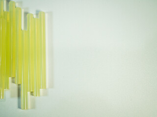 Crafting with glue sticks shows an arrangement of yellow rods for adhering various materials on a...