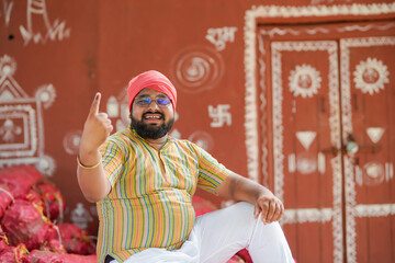 farmer showing finger or voting sign after voting