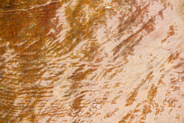 Old rusty metal texture. Abstract orange background. Blue rock with ripples on the surface. Defocus blurred transparent blue colored clear calm water surface texture with splashes and bubbles. Stone.