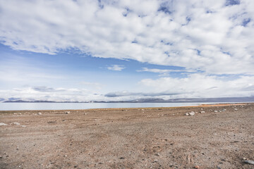 Lake Karakul in the Pamir mountains in the Tien Shan against the background of high rocky peaks, morning panorama of the lake for the background