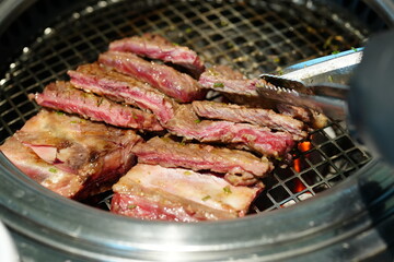 Korean BBQ with Raw Beef Short Ribs Grilled on Charcoal at Local Galbi Restaurant