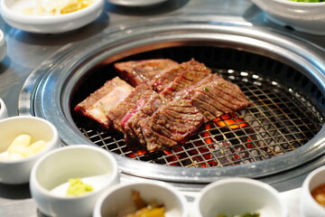 Korean BBQ with Raw Beef Short Ribs Grilled on Charcoal at Local Galbi Restaurant