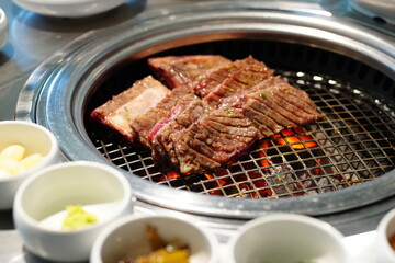 Korean BBQ with Raw Beef Short Ribs Grilled on Charcoal at Local Galbi Restaurant