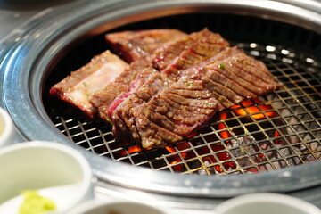 Korean BBQ with Raw Beef Short Ribs Grilled on Charcoal at Local Galbi Restaurant
