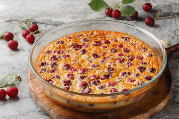 Cherry clafoutis is the taste of summer, fruity and generous close-up in a baking dish on the table. Horizontal