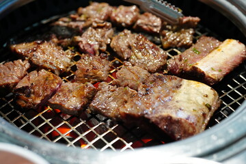 Korean BBQ with Raw Beef Short Ribs Grilled on Charcoal at Local Galbi Restaurant