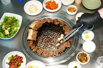 Korean BBQ with Raw Beef Short Ribs Grilled on Charcoal at Local Galbi Restaurant