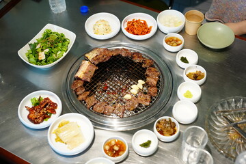 Korean BBQ with Raw Beef Short Ribs Grilled on Charcoal at Local Galbi Restaurant