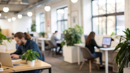 Defocused coworking space with desks, plants, and contemporary furniture